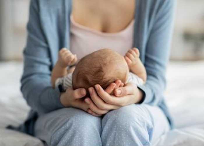 A newborn baby on mother's lap A newborn baby on mother's lap